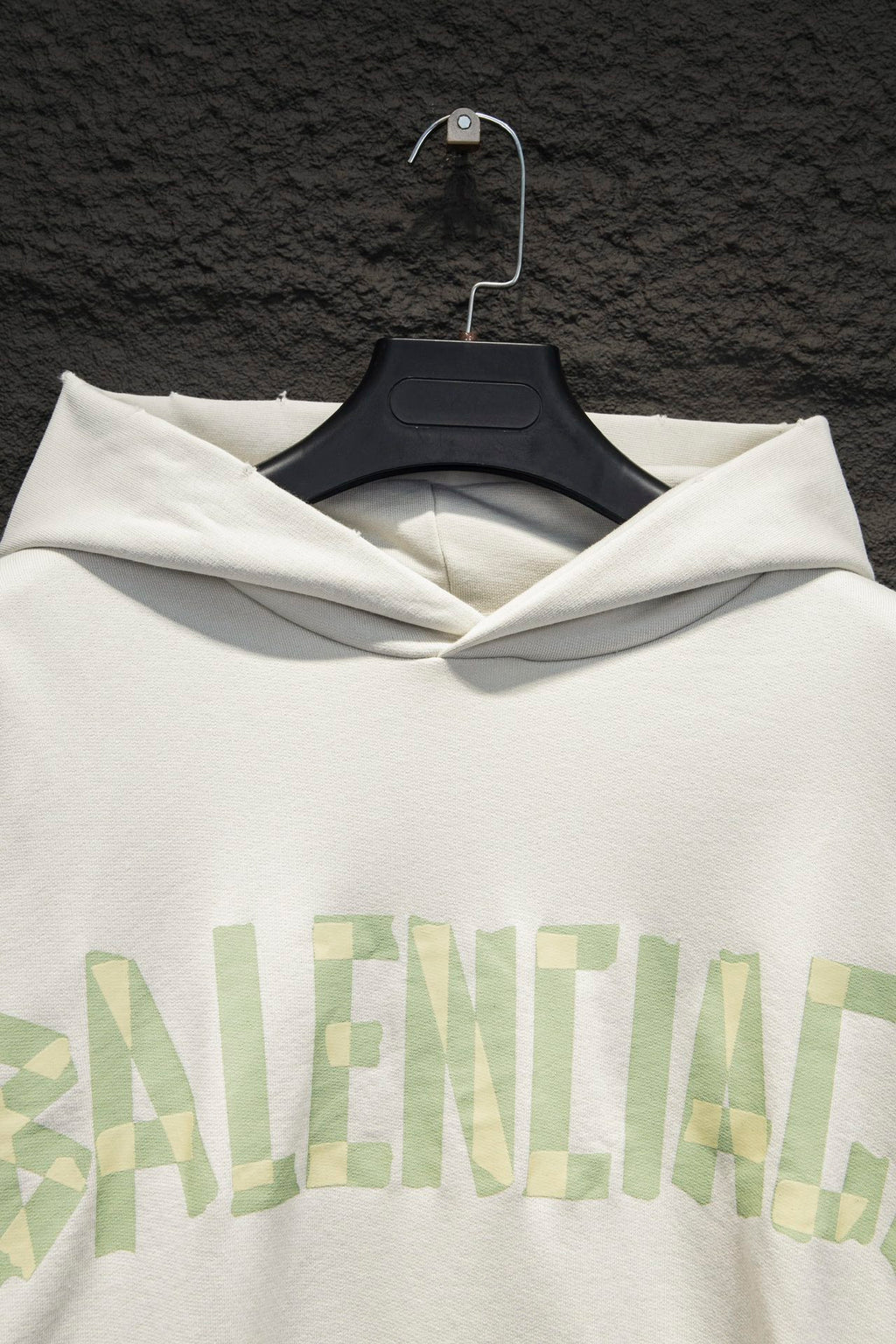 Off-white hoodie front with hood and large light-green logo print