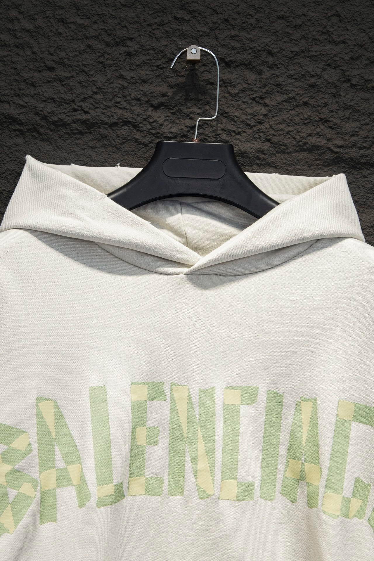 Off-white hoodie front with hood and large light-green logo print