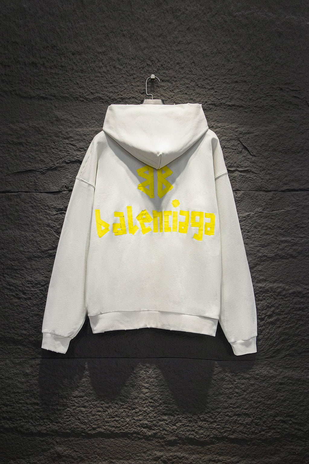 Off-white hoodie with hood and large yellow back graphic logo