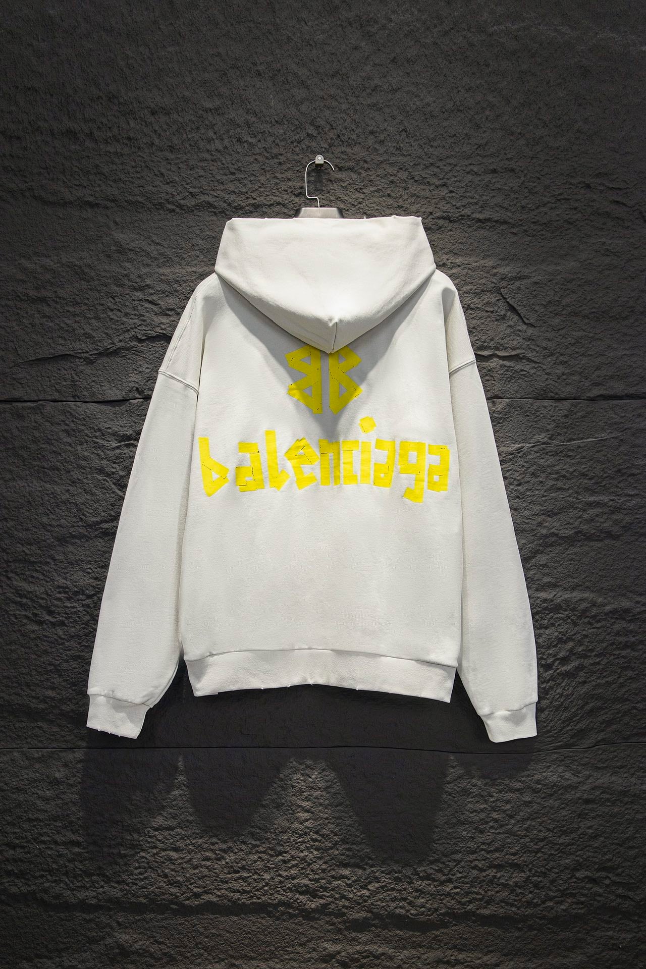 Off-white hoodie with hood and large yellow back graphic logo