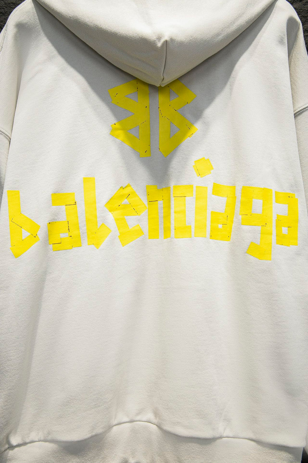 Off-white hoodie with hood and large yellow back graphic logo
