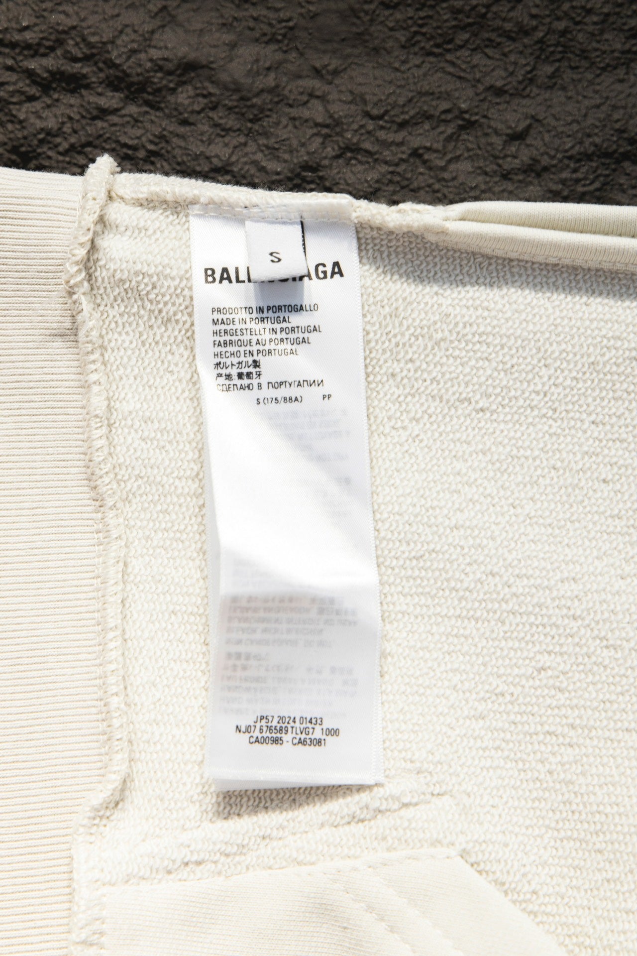 Off-white hoodie interior care label at hem opening