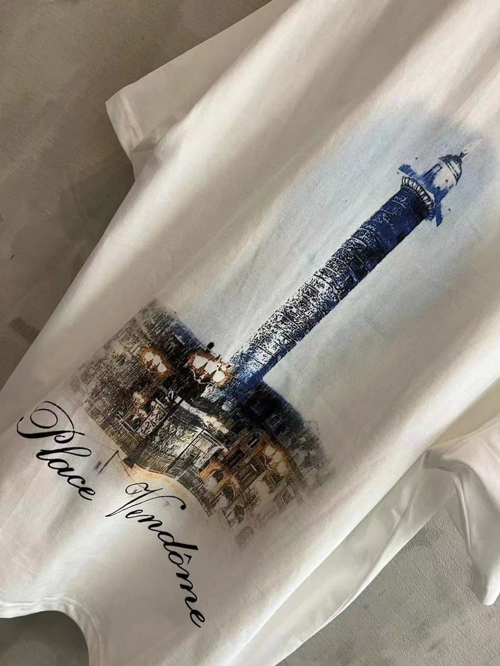 White T-shirt with blue tower and 'Place Vendome' script graphic.