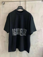 Black crew-neck T-shirt with large distressed “AGAINST” graphic print on the front