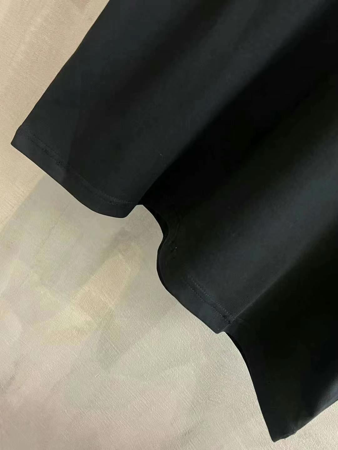 Black T-shirt sleeve and hem close-up
