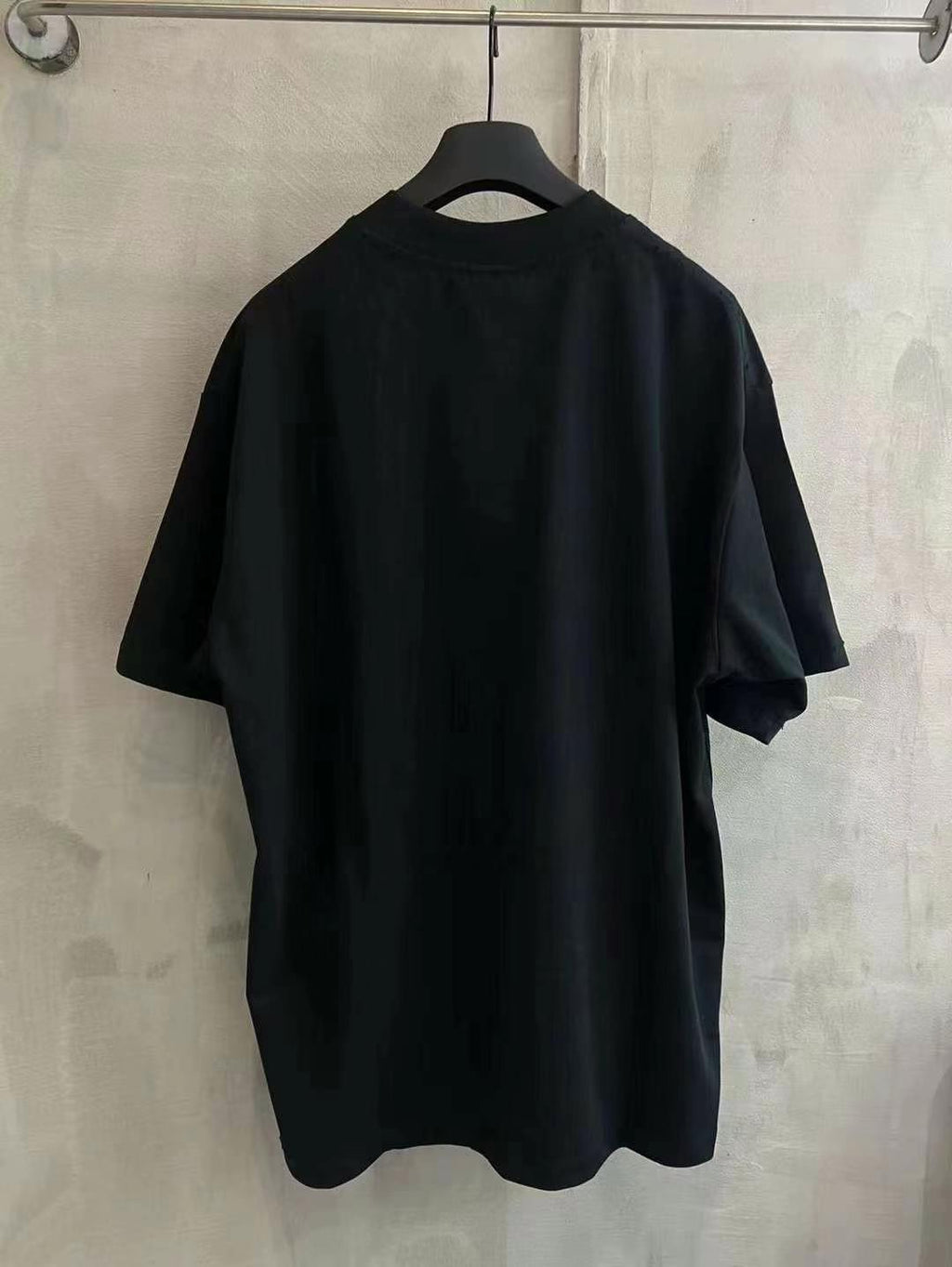 Black crew-neck T-shirt with short sleeves, shown from the back
