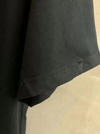 Black T-shirt hem with visible stitching detail