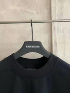 Black crew-neck T-shirt neckline close-up with inner collar branding