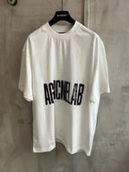 Balenciaga white graphic T-shirt with black AGAINCELAB text on the front