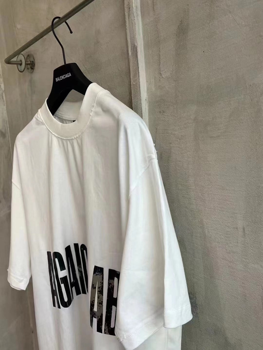 Balenciaga white graphic T-shirt with AGAINCELAB logo text on the sleeve area
