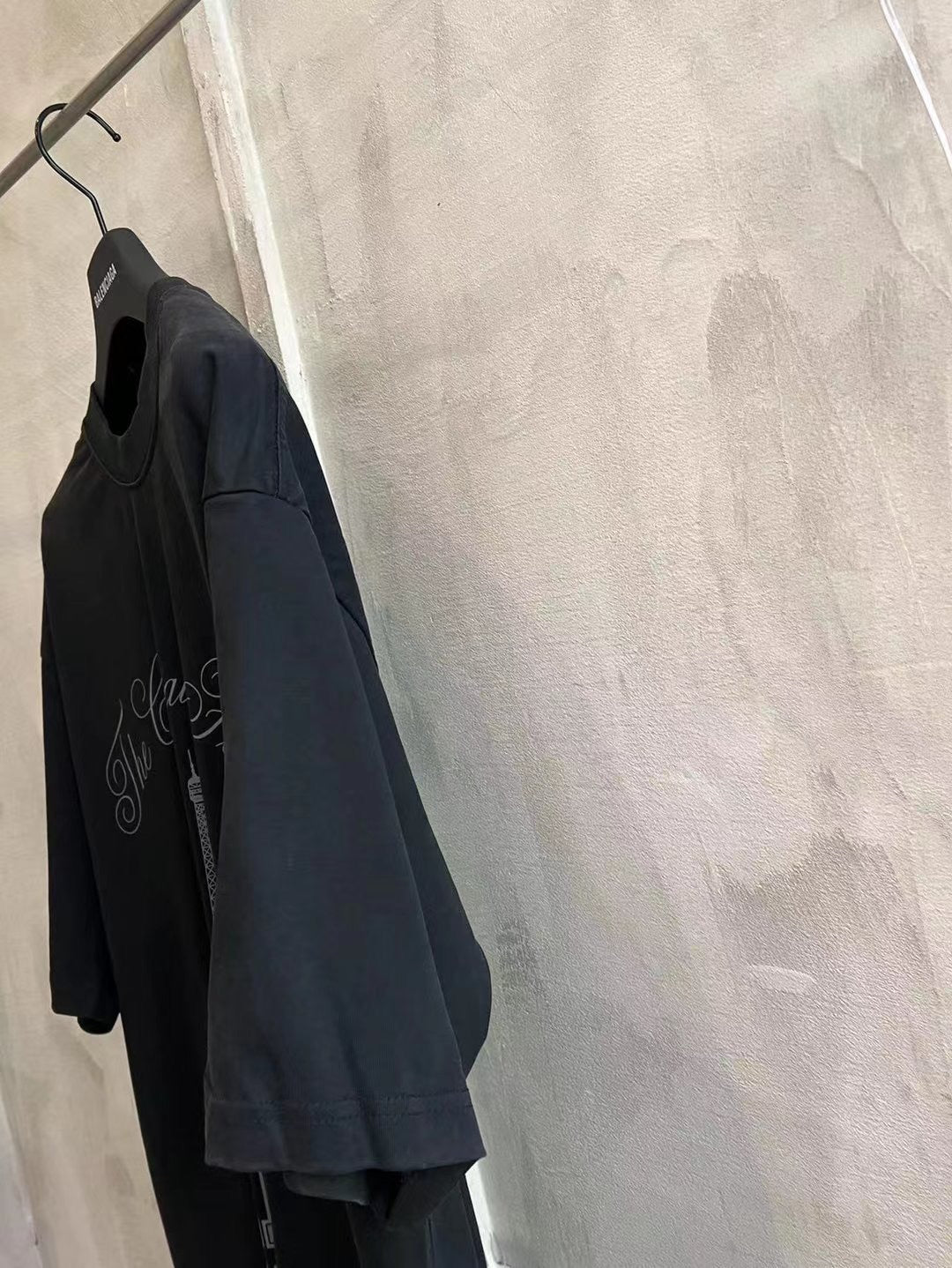Balenciaga dark blue T-shirt with crew neck and front graphic, side view
