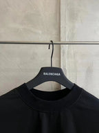 Balenciaga black T-shirt neckline on hanger, crew neck and tag text