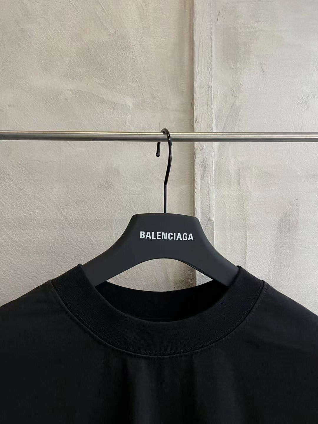 Balenciaga black T-shirt neckline on hanger, crew neck and tag text