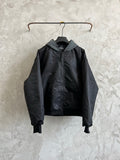 Dark hooded zip jacket with two front pockets and ribbed cuffs