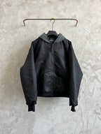 Dark hooded zip jacket with two front pockets and ribbed cuffs