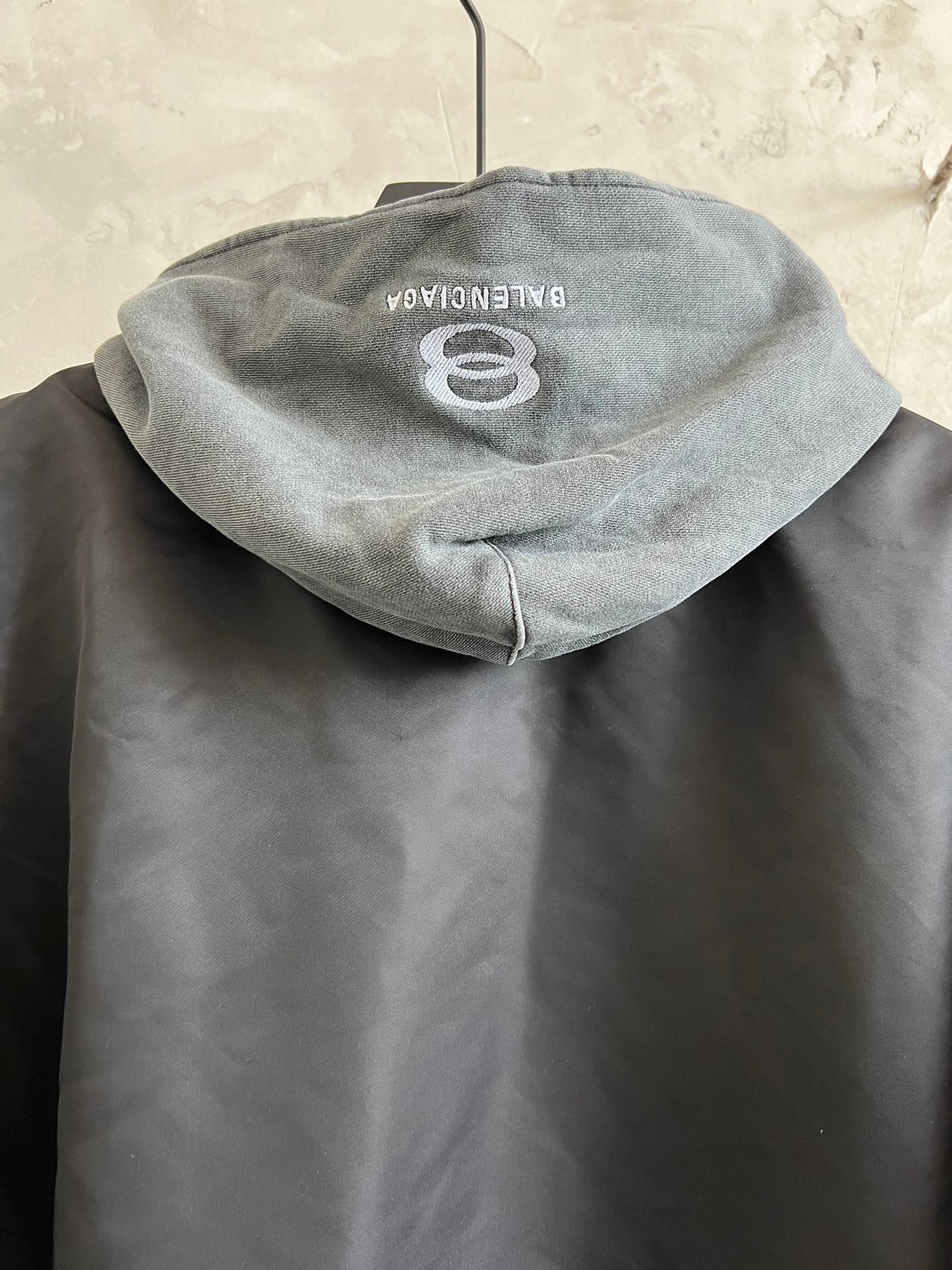 Dark hooded jacket with heather gray hood and embroidered 8 logo on back