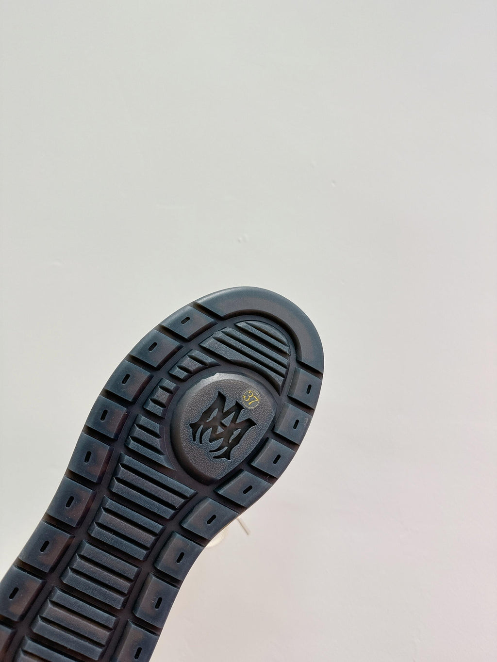 Amiri boot outsole, dark tread with embossed logo and channel grip pattern