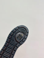 Amiri boot outsole, dark tread with embossed logo and channel grip pattern