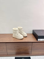 Amiri lace-up ankle boots in light beige, side view with plush faux-fur cuffs