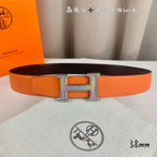 Orange leather belt with silver-tone H buckle, laid flat