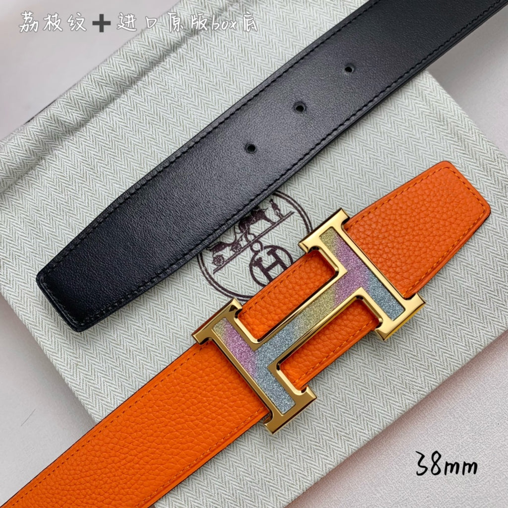Orange belt with black leather strap with holes and silver-tone H buckle