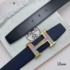 Navy leather belt close-up with gold H buckle and punched holes