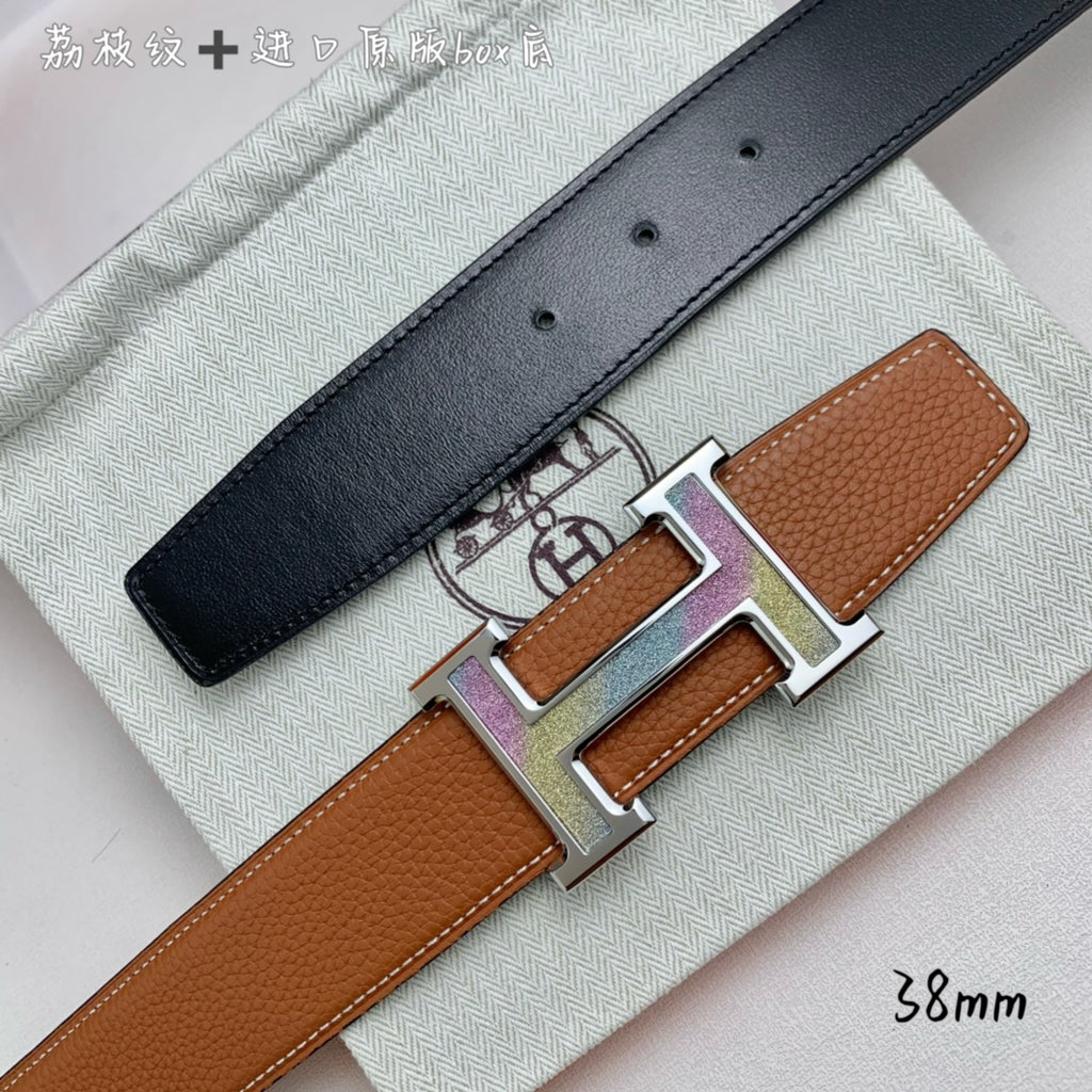 Black leather belt with silver-tone H buckle over tan keeper, adjustable holes