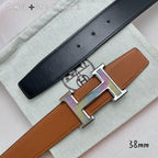 Black leather belt with silver-tone H buckle over tan keeper, adjustable holes