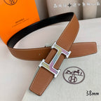 Tan leather belt with gold-tone and silver-tone H buckle and leather keeper
