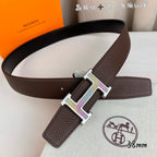 Brown leather belt with gold and silver H buckle and leather keeper strap