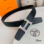 Leather belt with black strap and gold H buckle with purple inserts, end holes
