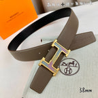 Hermes belt with brown leather strap and gold H buckle close up