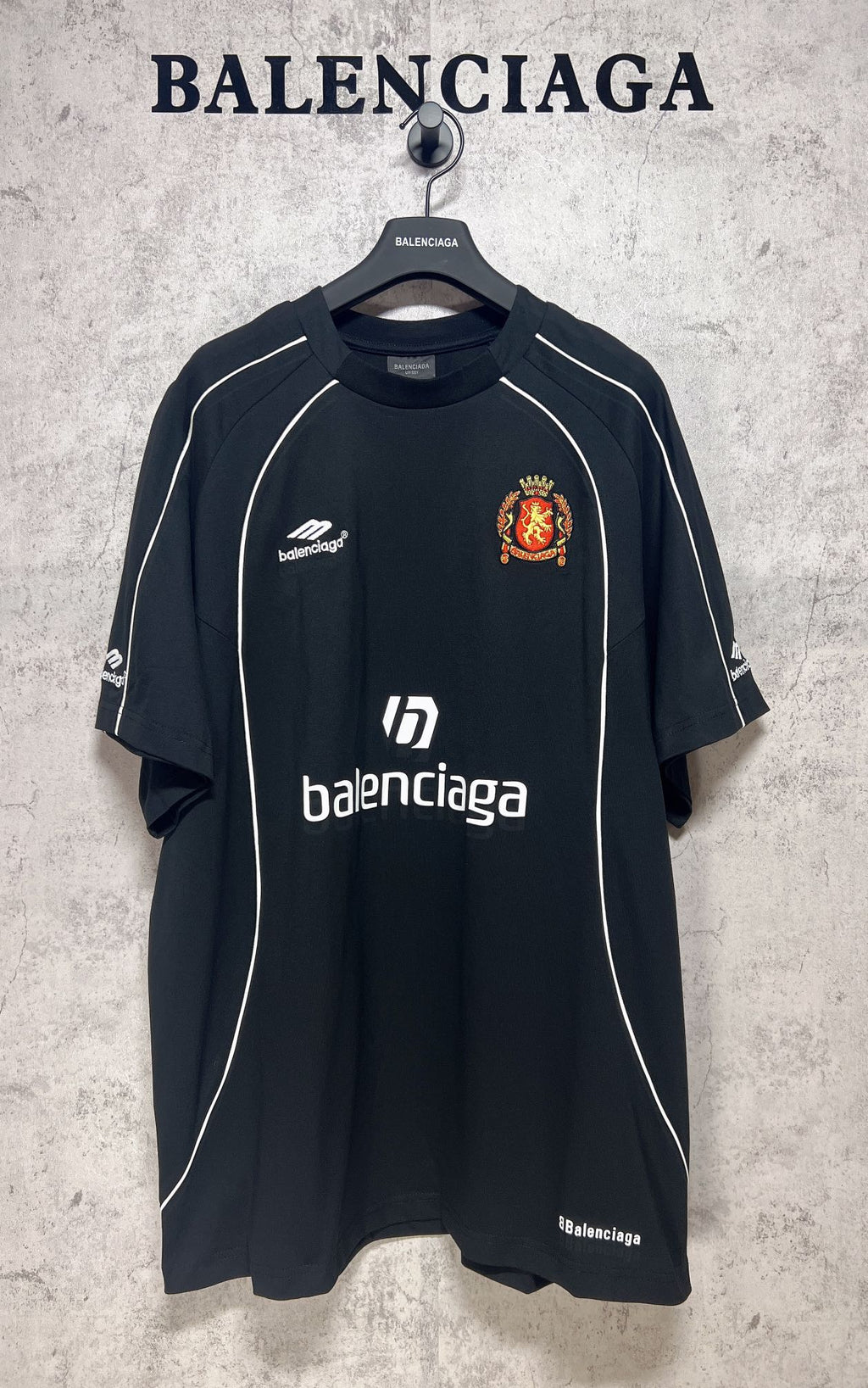 Balenciaga short-sleeve T-shirt, dark front with balenciaga branding and crest
