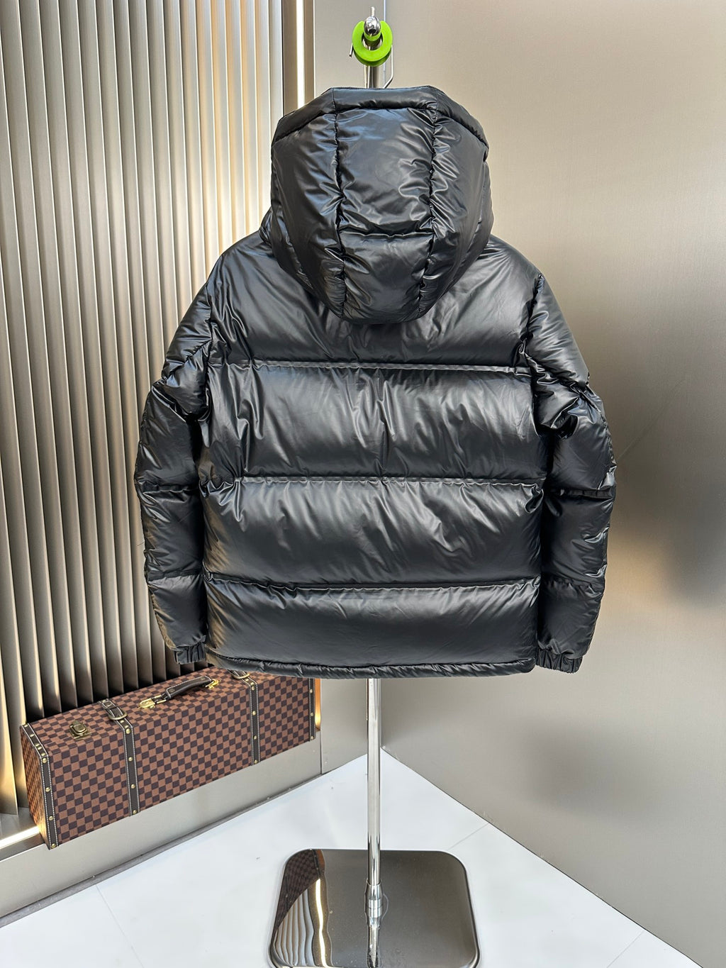 Prada long hooded puffer jacket, dark quilted back view with padded sleeves