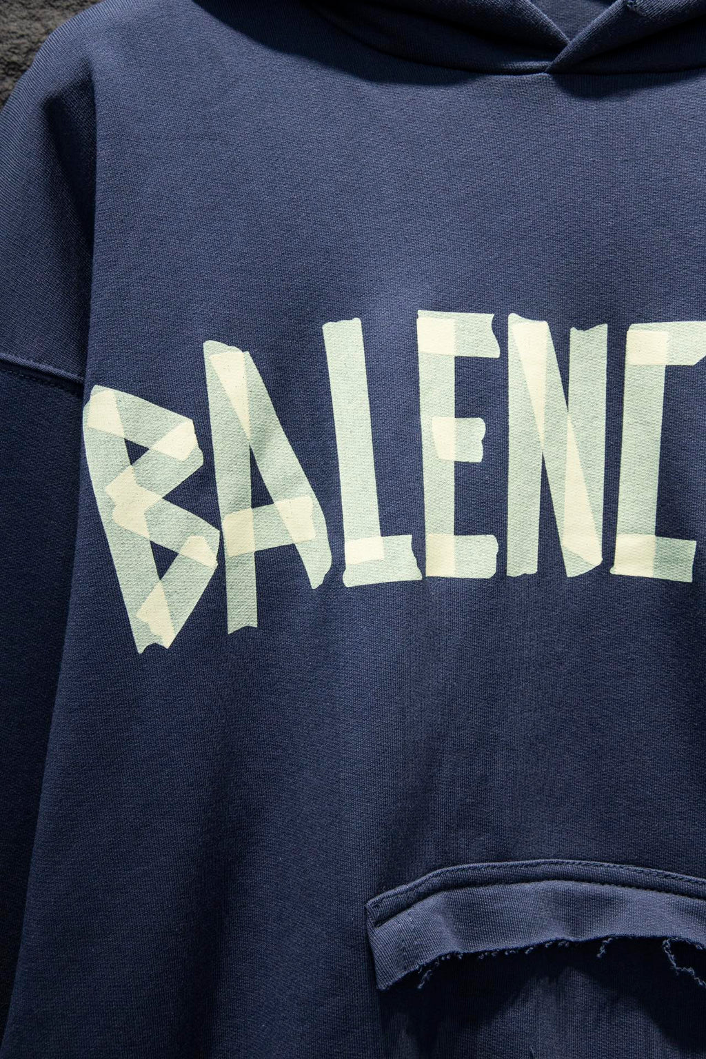 Balenciaga hoodie sleeve with large pale logo graphic and distressed print
