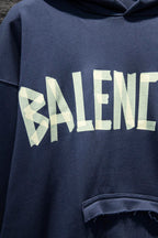 Balenciaga hoodie sleeve with large pale logo graphic and distressed print