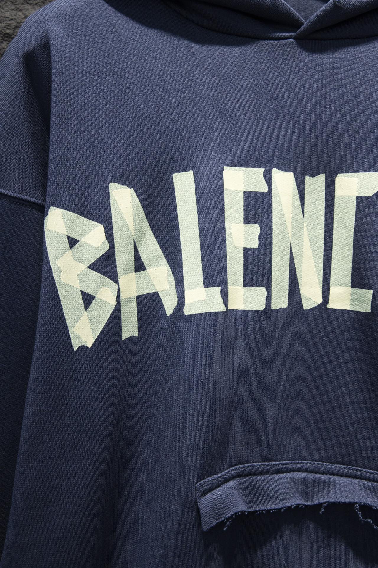 Balenciaga hoodie sleeve with large pale logo graphic and distressed print