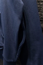 Balenciaga hoodie side view with ribbed cuff and dark blue fabric