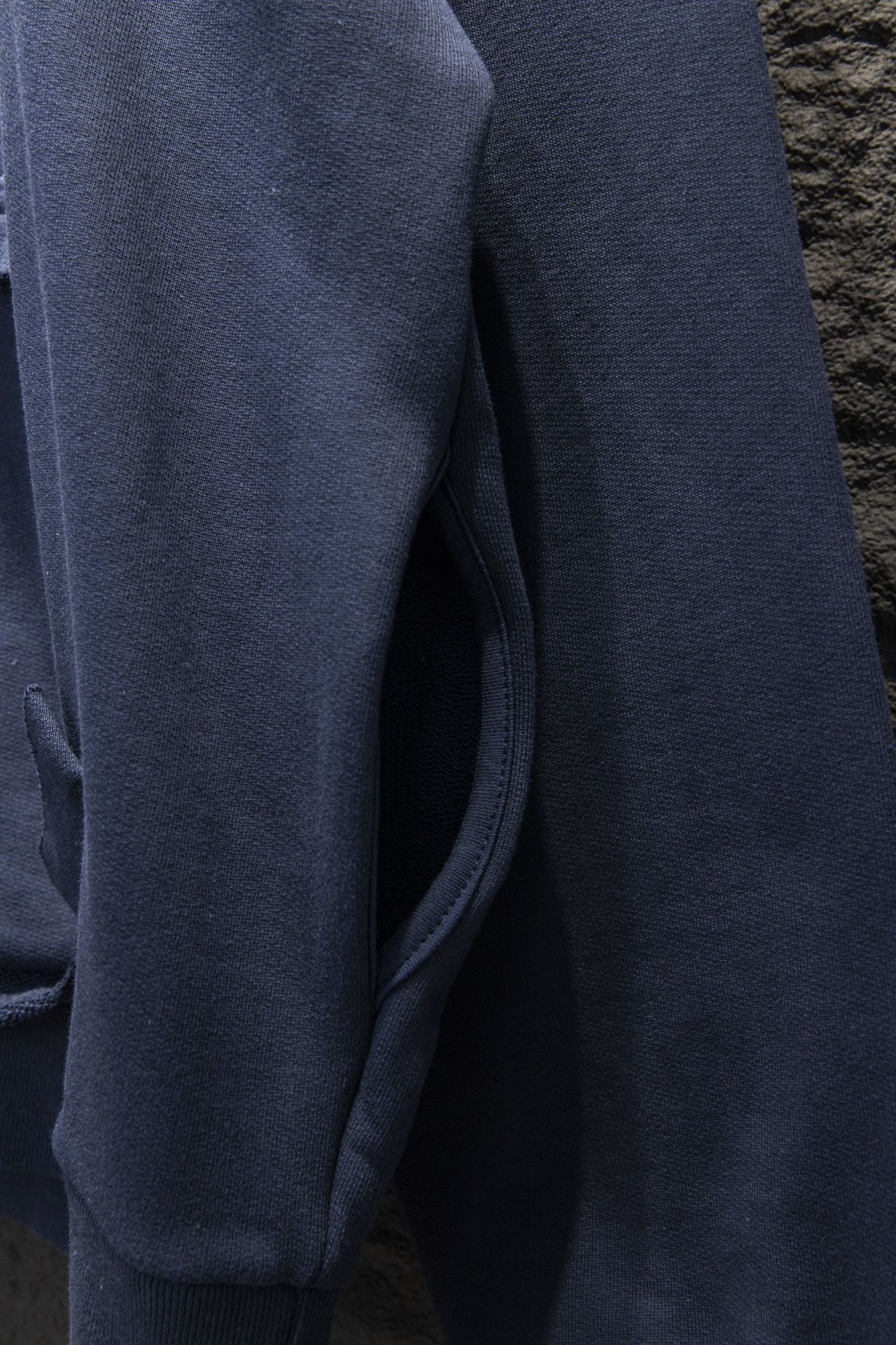 Balenciaga hoodie side view with ribbed cuff and dark blue fabric
