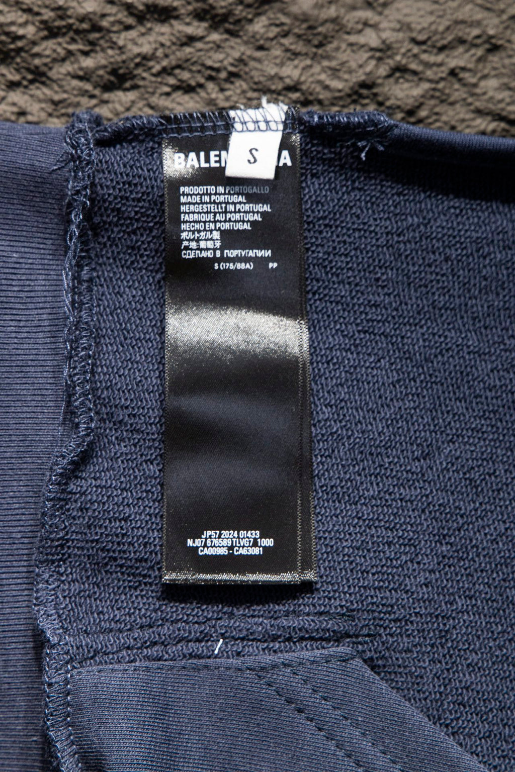 Balenciaga hoodie interior care label on dark blue knit fabric