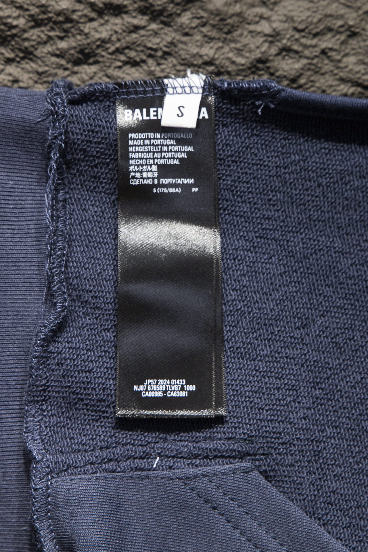 Balenciaga hoodie interior care label on dark blue knit fabric