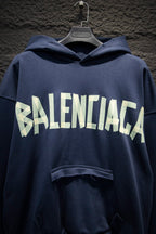 Balenciaga hoodie close-up with white BALENCIAGA logo across chest