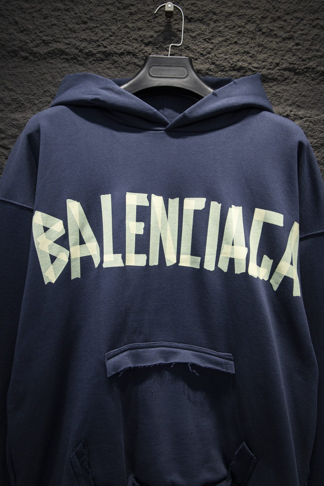 Balenciaga hoodie close-up with white BALENCIAGA logo across chest