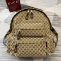 Gucci GG monogram backpack with front zip pocket and brown leather trim