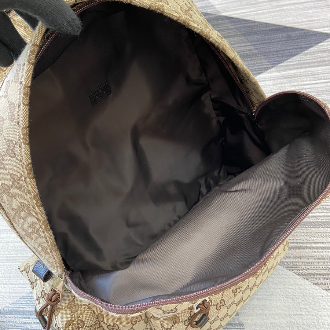 Gucci GG monogram backpack interior with fabric lining and zip pocket
