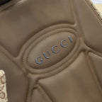 Gucci embossed logo on brown leather backpack panel with stitched border