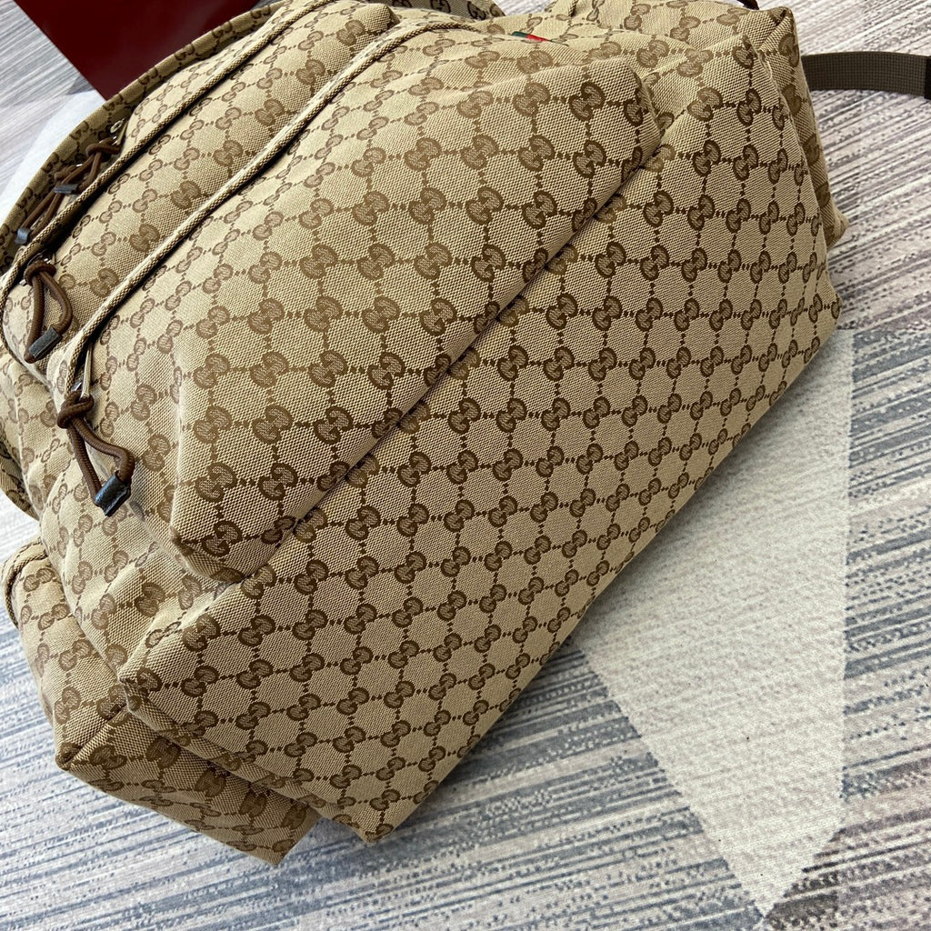 Gucci GG monogram backpack side view with adjustable strap and front pocket
