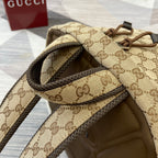 Gucci GG monogram backpack interior opening with brown leather trim and strap