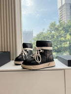 Amiri black high-top boot sneakers with cream laces on display, beige sole