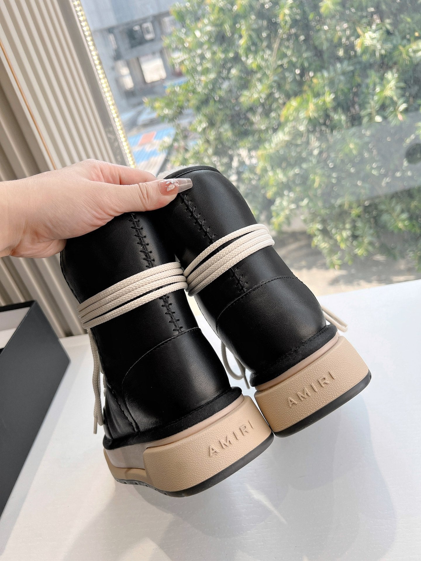 Amiri black high-top sneakers held by collar with cream laces and beige sole
